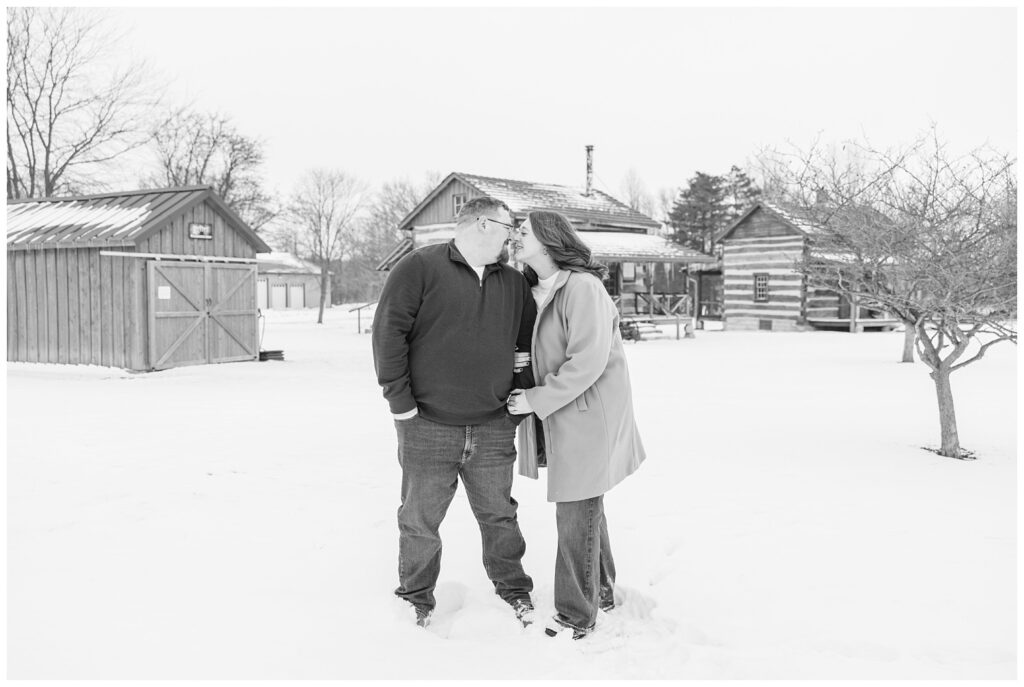 engaged couple hugging and posing in the snow at Bloomville, OH portrait session