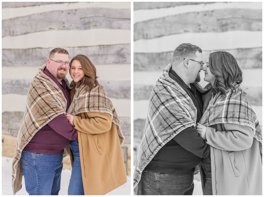 couple snuggling with a blanket front of a log cabin with Bloomville, OH engagement photographer