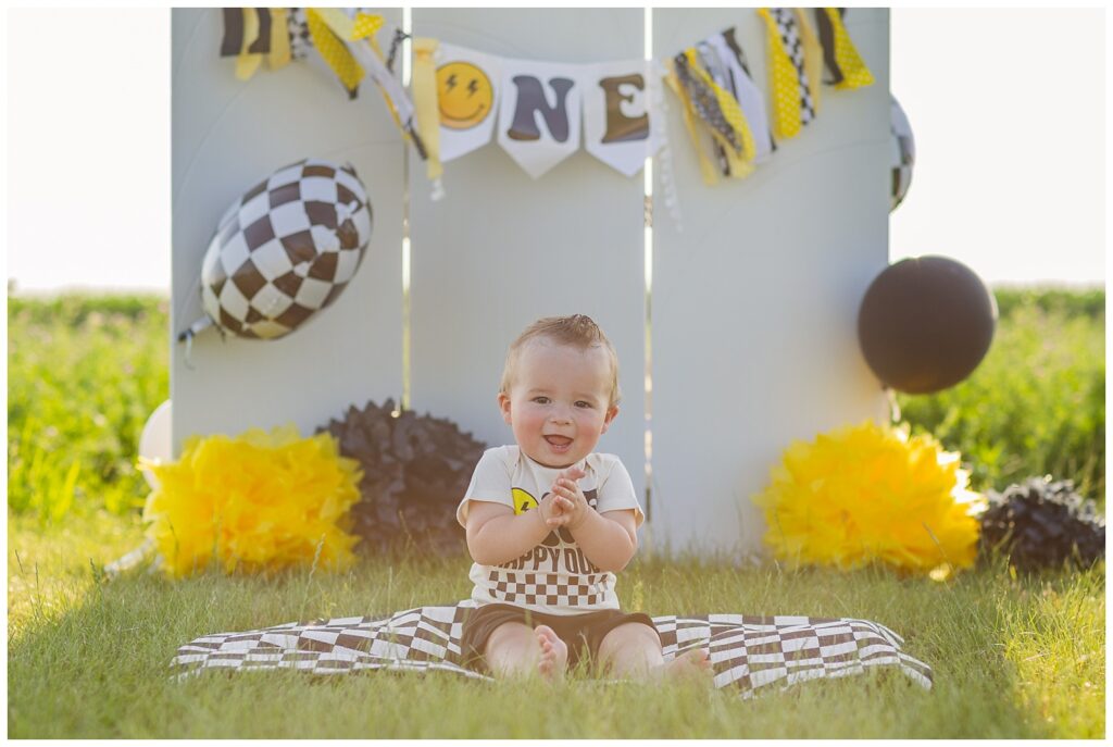 little one year old boy sitting on a black and white blanket for Tiffin, Ohio cake smash session