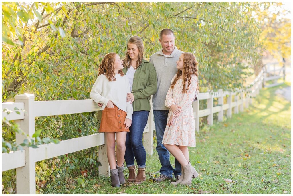 Tiffin, Ohio extended family session photographer shooting under trees next to white fence