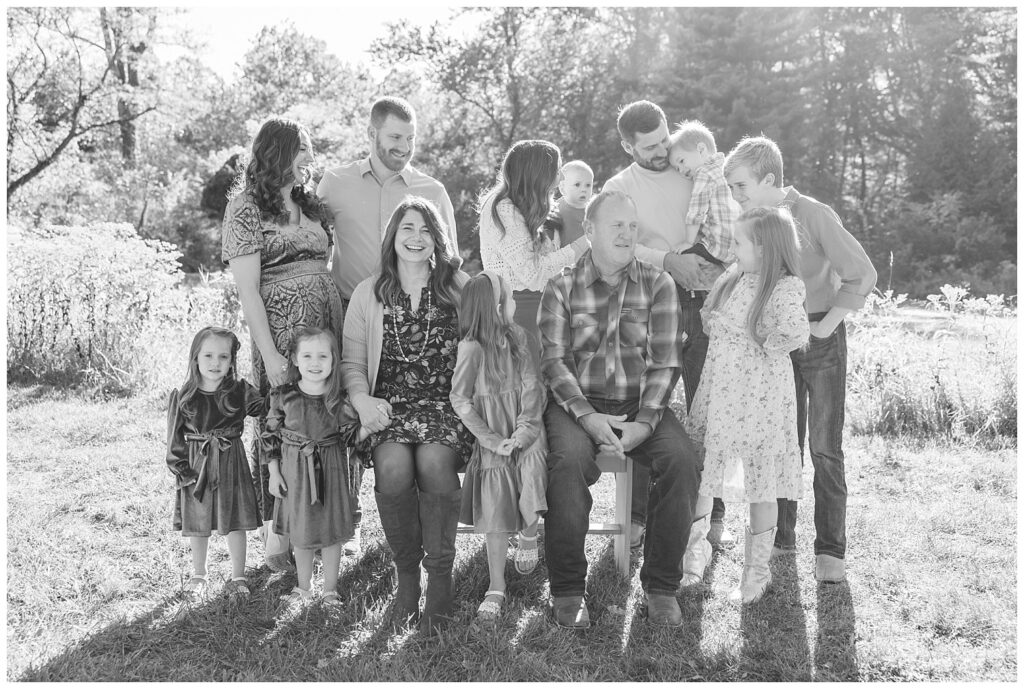 tree generations of a family posing together near a pond for extended session in Fremont, Ohio