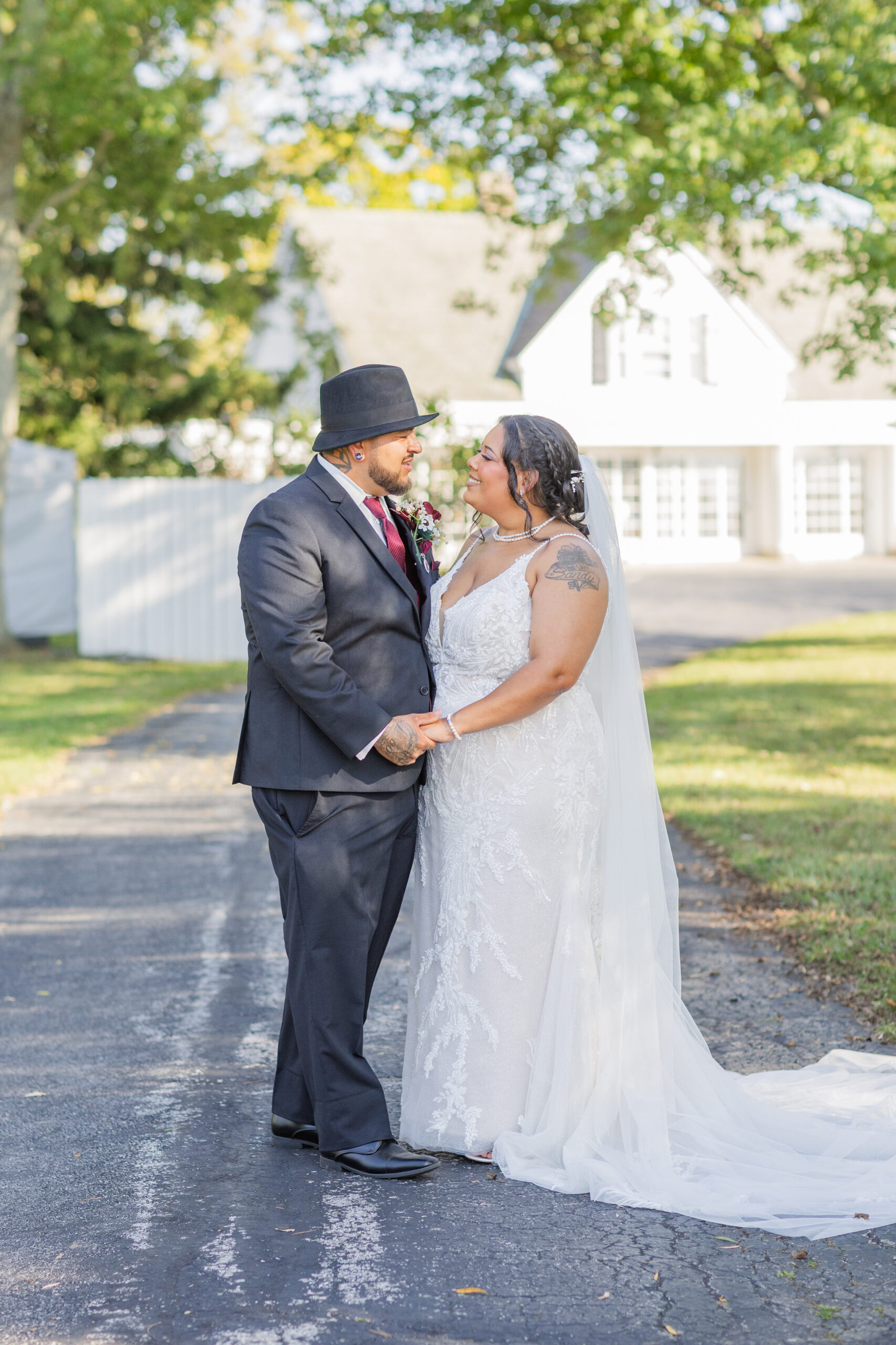 wedding couple holding hands on the driveway of wedding venue