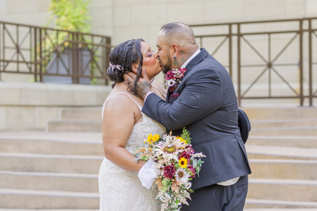 wedding couple sharing a kiss while the bride holds her bouquet in Tiffin, Ohio