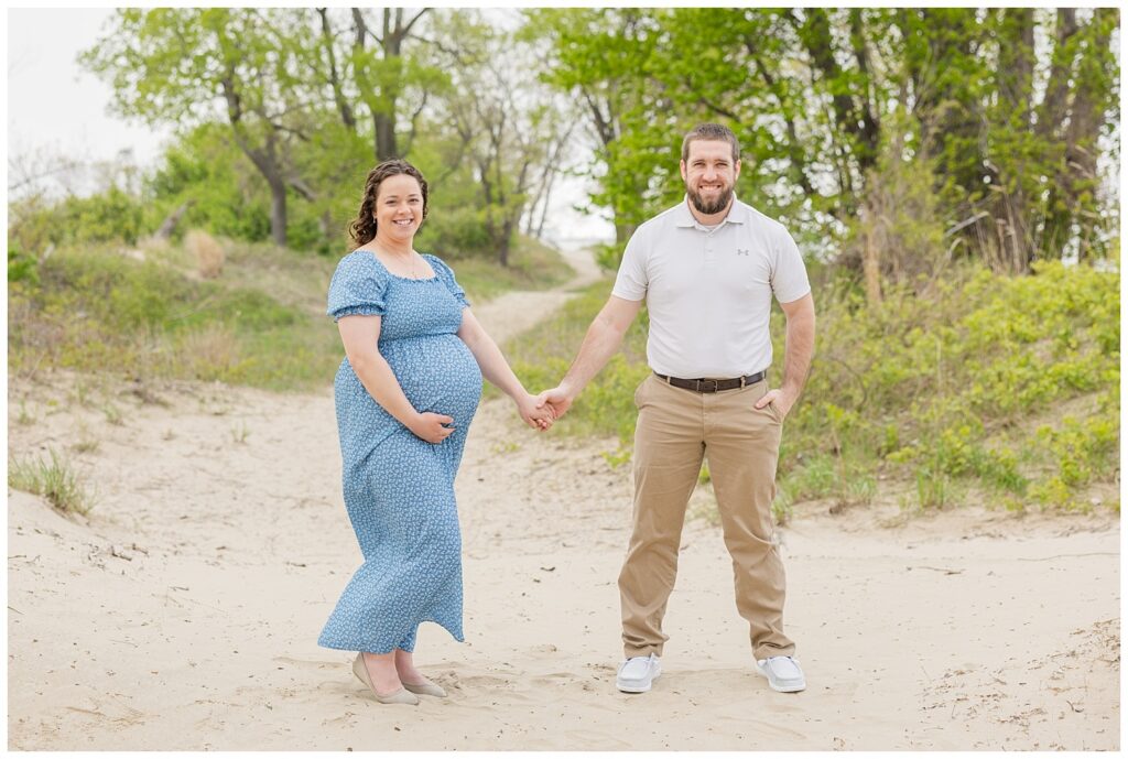 couple standing together on the sand for Lake Erie maternity session