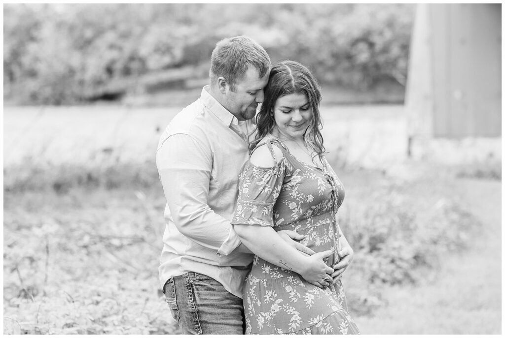 husband wrapping his arms around his wife's belly during their Tiffin, Ohio pregnancy announcement session