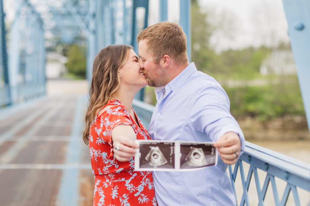married couple showing off their ultrasound picture at Tindall Bridge maternity session